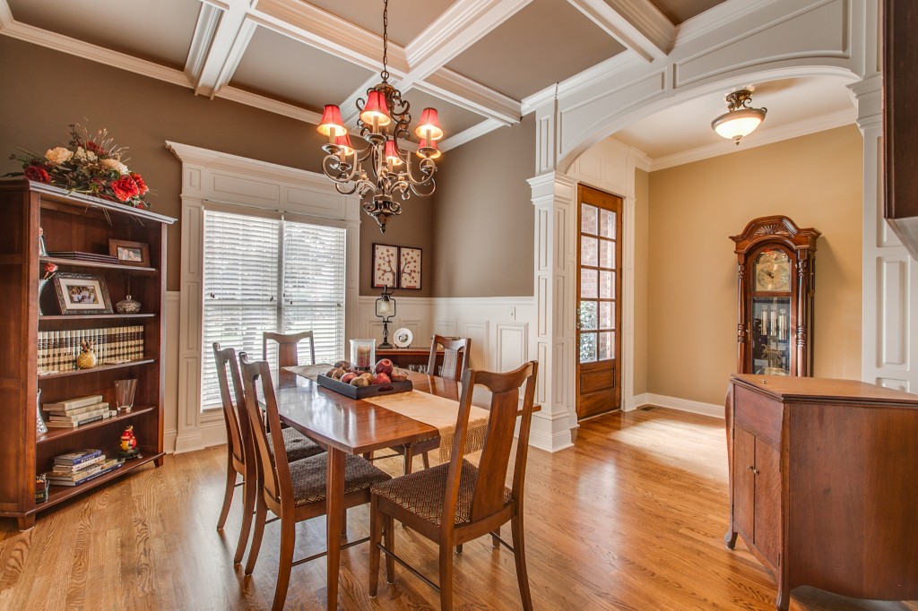 The coffered ceiling adds form and visual balance to the dining room off the front entryway. This cheery room is a wonderful place to spend your family meals.
