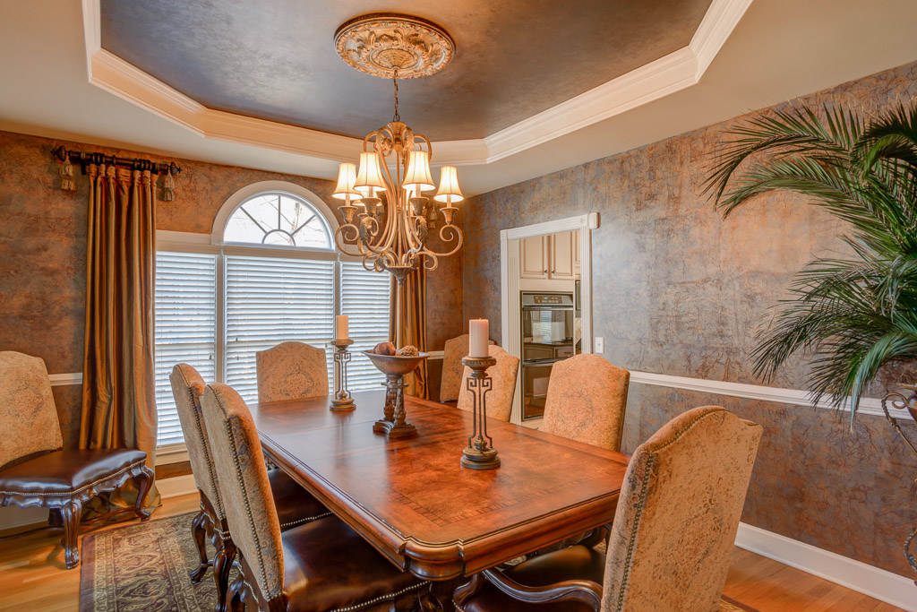 Custom faux painted walls and ceiling will surely impress your guests in this elegant formal dining room.