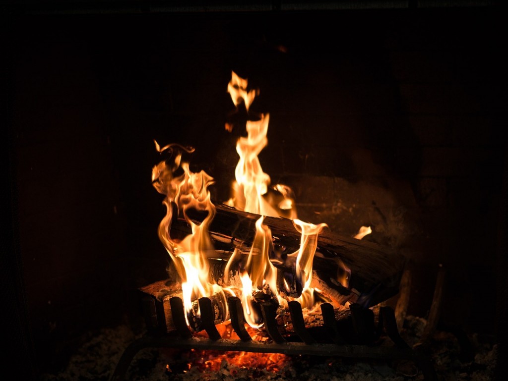roaring wood fire inside of a fireplace