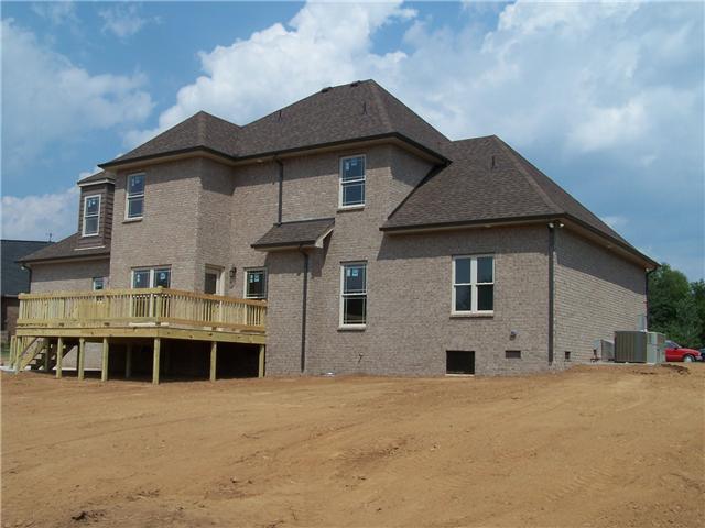View of the back of the home, large deck and back yard