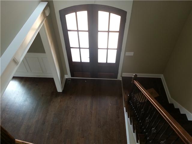 Lovely entry way with upscale trim, hardwoods, decorative staircase and contemporary entryway